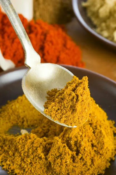 Curry spice in spoon — Stock Photo, Image