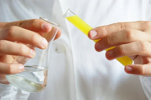 Laboratory assistant with test tubes in hand — Stock Photo, Image