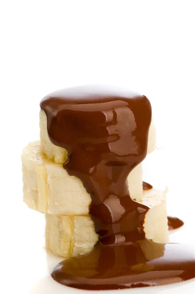 Slices of banana with pouring chocolate — Stock Photo, Image