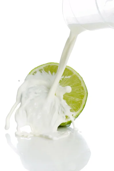 Lime with splashing milk — Stock Photo, Image