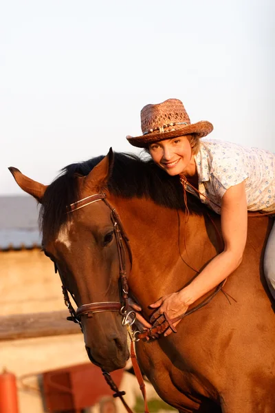 Woman on brown horse — Stock Photo, Image