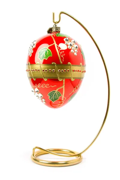 Easter egg hanging on golden stand — Stock Photo, Image