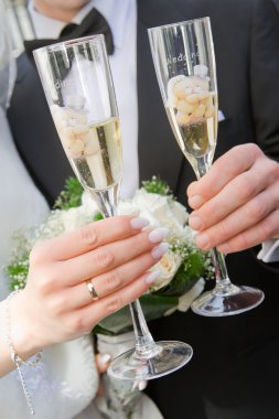 Hands with rings and glasses of wine clipart