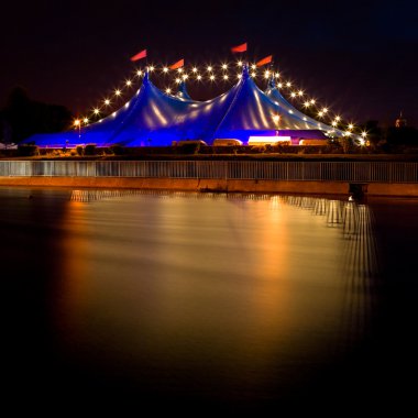 Circus style blue tent and row of lights at night clipart