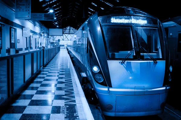 Passenger train inside the station, monochromatic — Stock Photo, Image