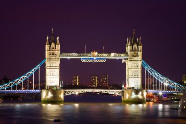 Tower Bridge illuminated at night time clipart