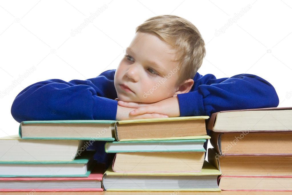 Young boy with hands on top of books, isolated