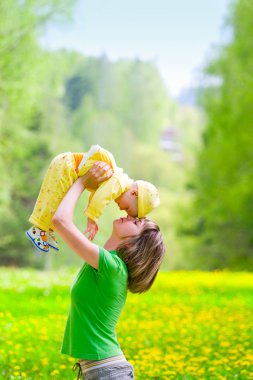 Mother with baby in the park clipart