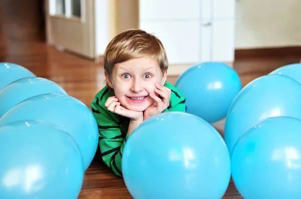Мальчик лежал с воздушными шарами — стоковое фото