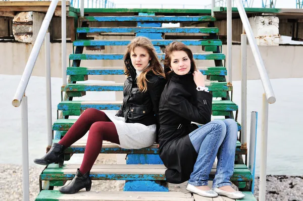 Girls sitting on the stairs — Stock Photo, Image