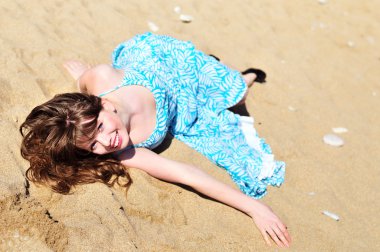 Girl laying on the sand