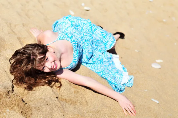 Girl laying on the sand — Stok fotoğraf