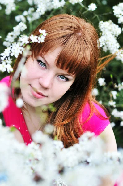 Redheaded girl in blossom — Stock Photo, Image