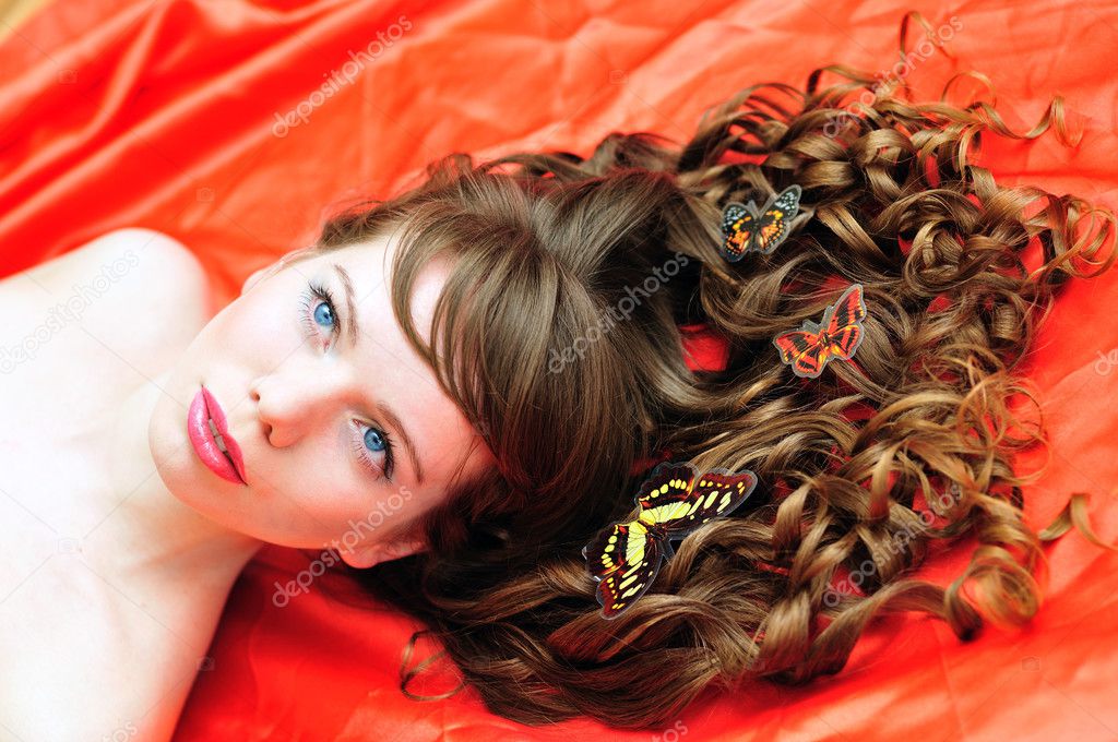 Beautiful girl with butterfly in her hair