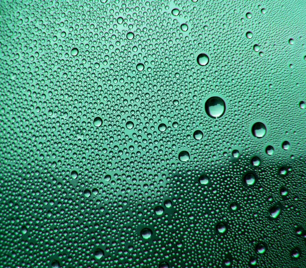 Green glass with drops — Stock Photo, Image