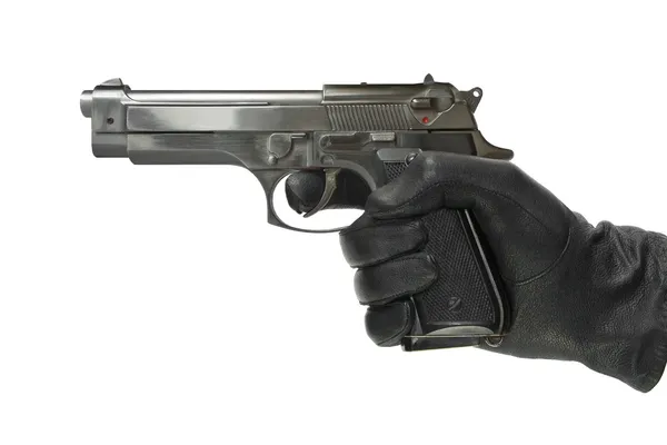 stock image Hand in glove with pistol