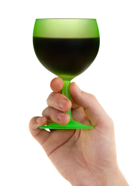 Hand with green glass of red wine — Stock Photo, Image