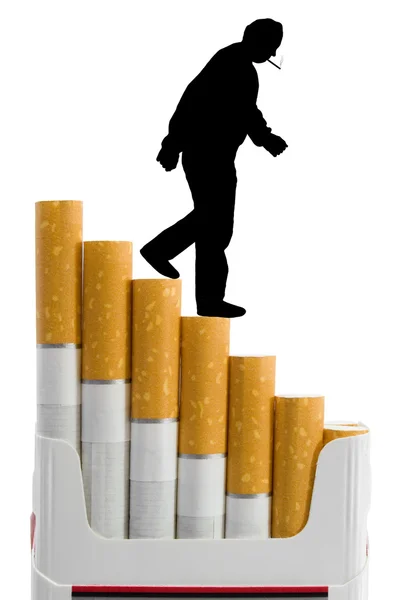 Cigarettes like a staircase and silhouette of smoker — Stock Photo, Image