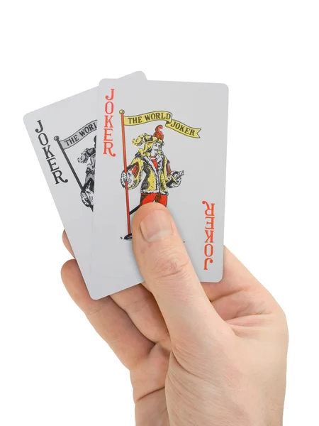 Hand with playing cards (two Jokers) — Stock Photo, Image