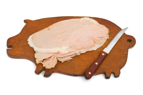 Domuz eti ve domuz şeklinde tahta üzerinde bıçak — Stok fotoğraf