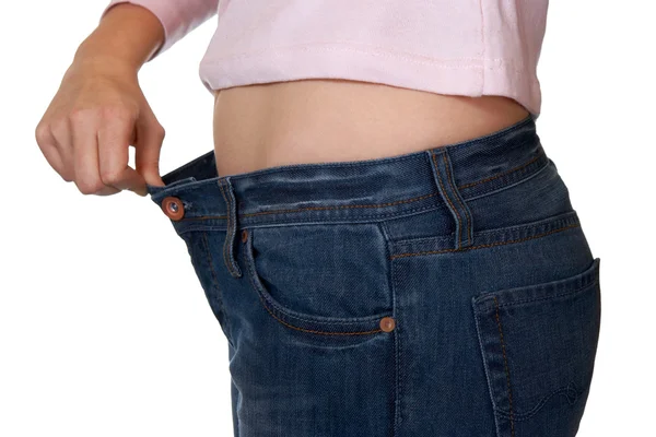 Mano y jeans - pérdida de peso — Foto de Stock