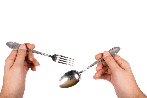 Fork and spoon in hands — Stock Photo, Image
