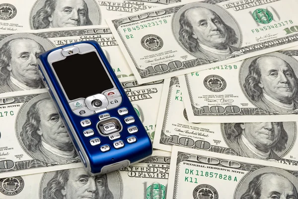 stock image Mobile phone on money background