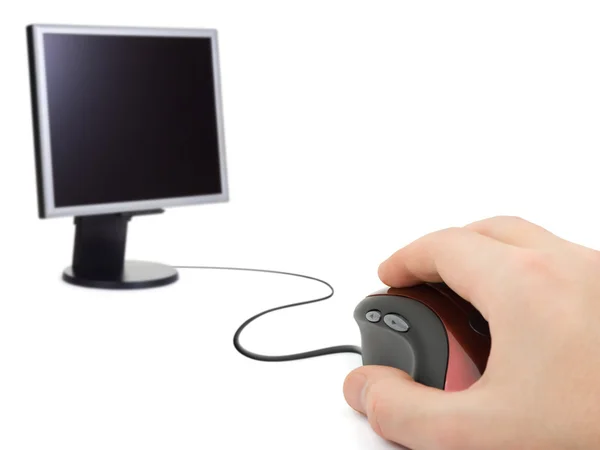 Hand with computer mouse and monitor — Stock Photo, Image