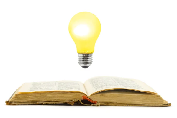 Livro retrô e lâmpada — Fotografia de Stock