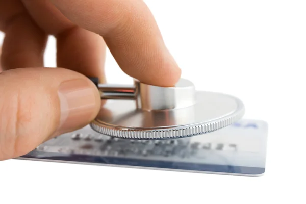 Hand with stethoscope and credit card — Stock Photo, Image