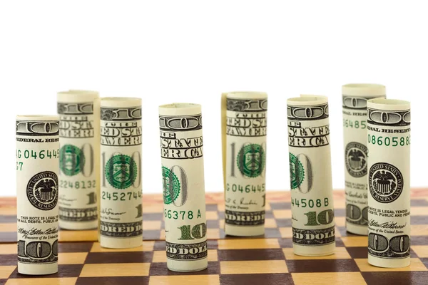 Pieniądze na szachownicy — Zdjęcie stockowe