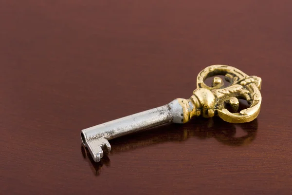Retro key on wooden table — Stock Photo, Image