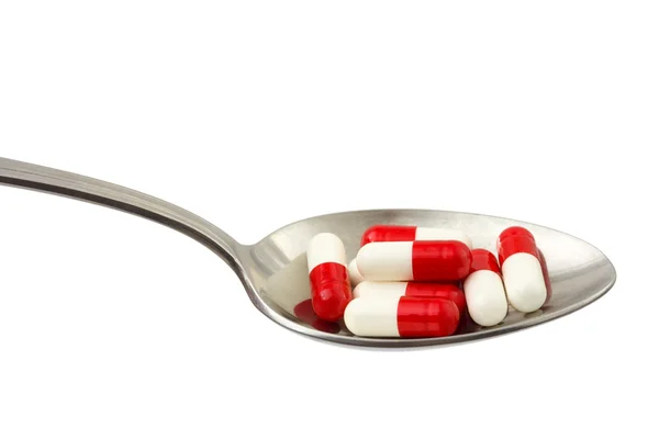 Spoon and pills — Stock Photo, Image