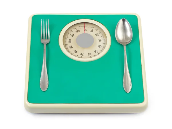 Garfo e colher na balança de peso — Fotografia de Stock