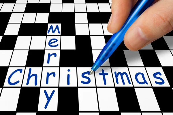 Hand filling in crossword - Merry Christmas — Stock Photo, Image