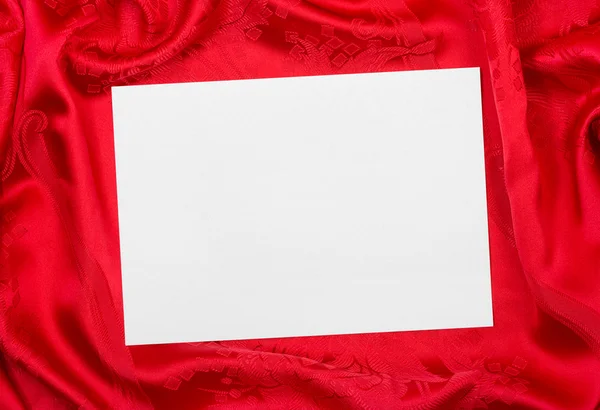 Greeting paper card on red cloth — Stock Photo, Image