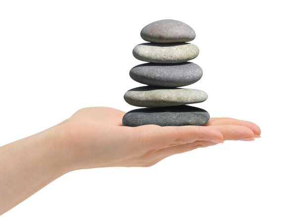 Stack of stones in hand isolated on white background