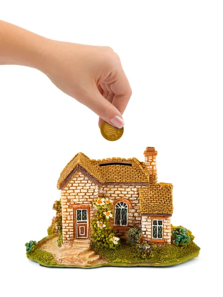Hand with coin and house bank — Stock Photo, Image