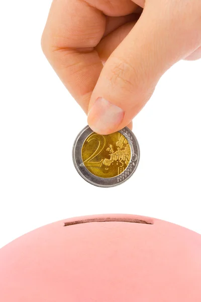 Hand with coin and piggy bank — Stock Photo, Image