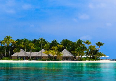 Water bungalows on a tropical island clipart