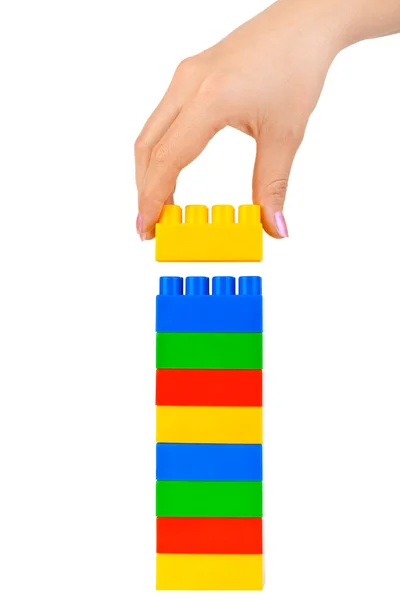 Hand and toy tower — Stock Photo, Image