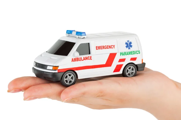 Mão com carro de ambulância brinquedo — Fotografia de Stock