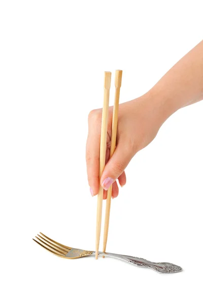 Mano con palillos y tenedor — Foto de Stock