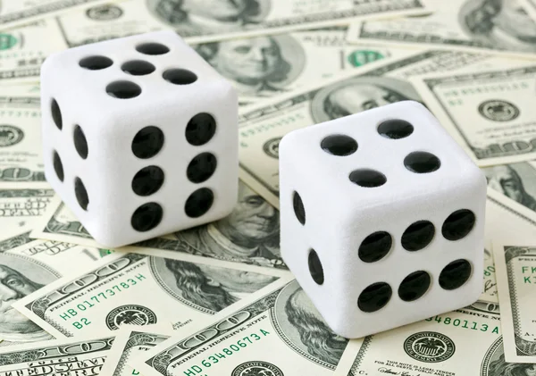 Two dices on money background — Stock Photo, Image