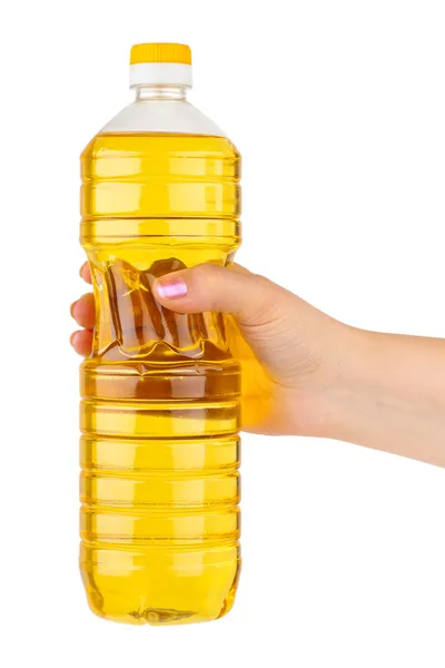 Mão com garrafa de óleo de cozinha — Fotografia de Stock