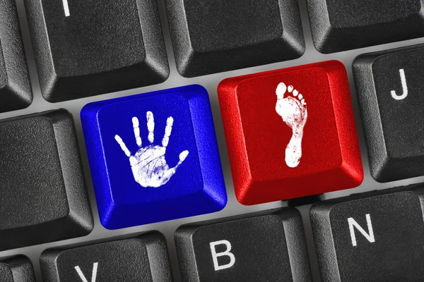 stock image Printout of hand and foot on computer keys
