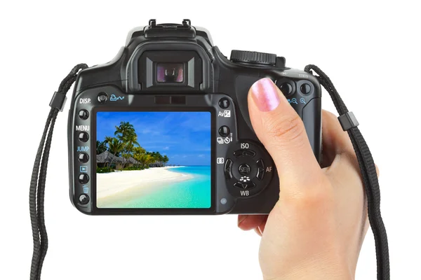 Camera in hand and beach landscape — Stock Photo, Image