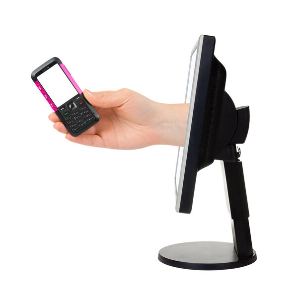 Computer screen and hand with phone