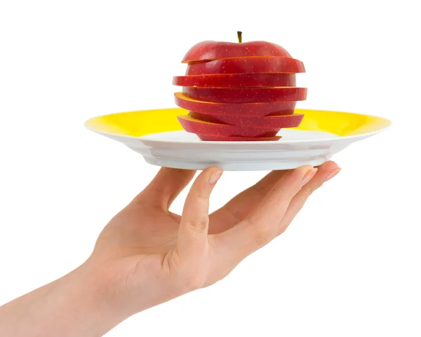 Hand with plate and chopped apple — Stock Photo, Image