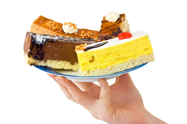 Hand und Teller mit Kuchen — Stockfoto